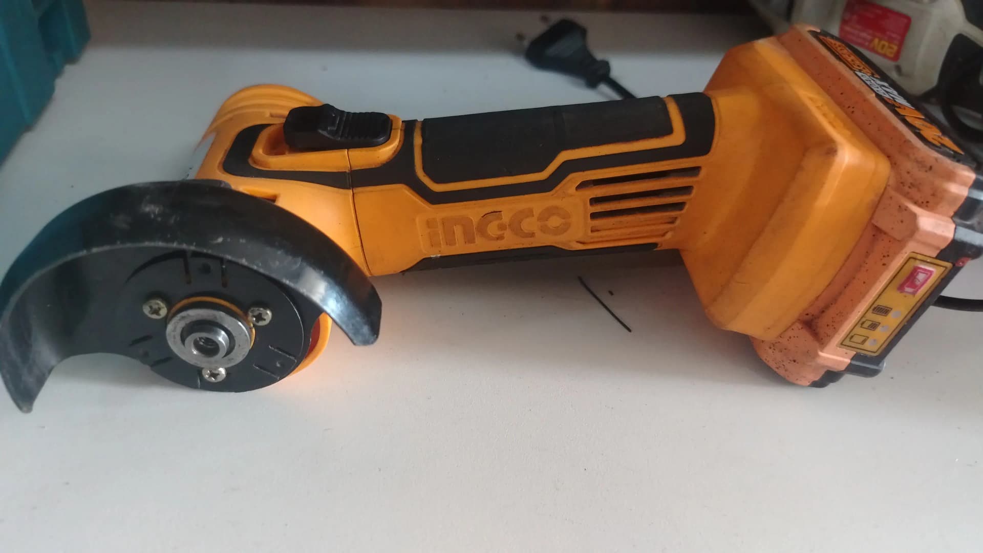 Used Ingco 20V mini angle grinder with a guard and battery