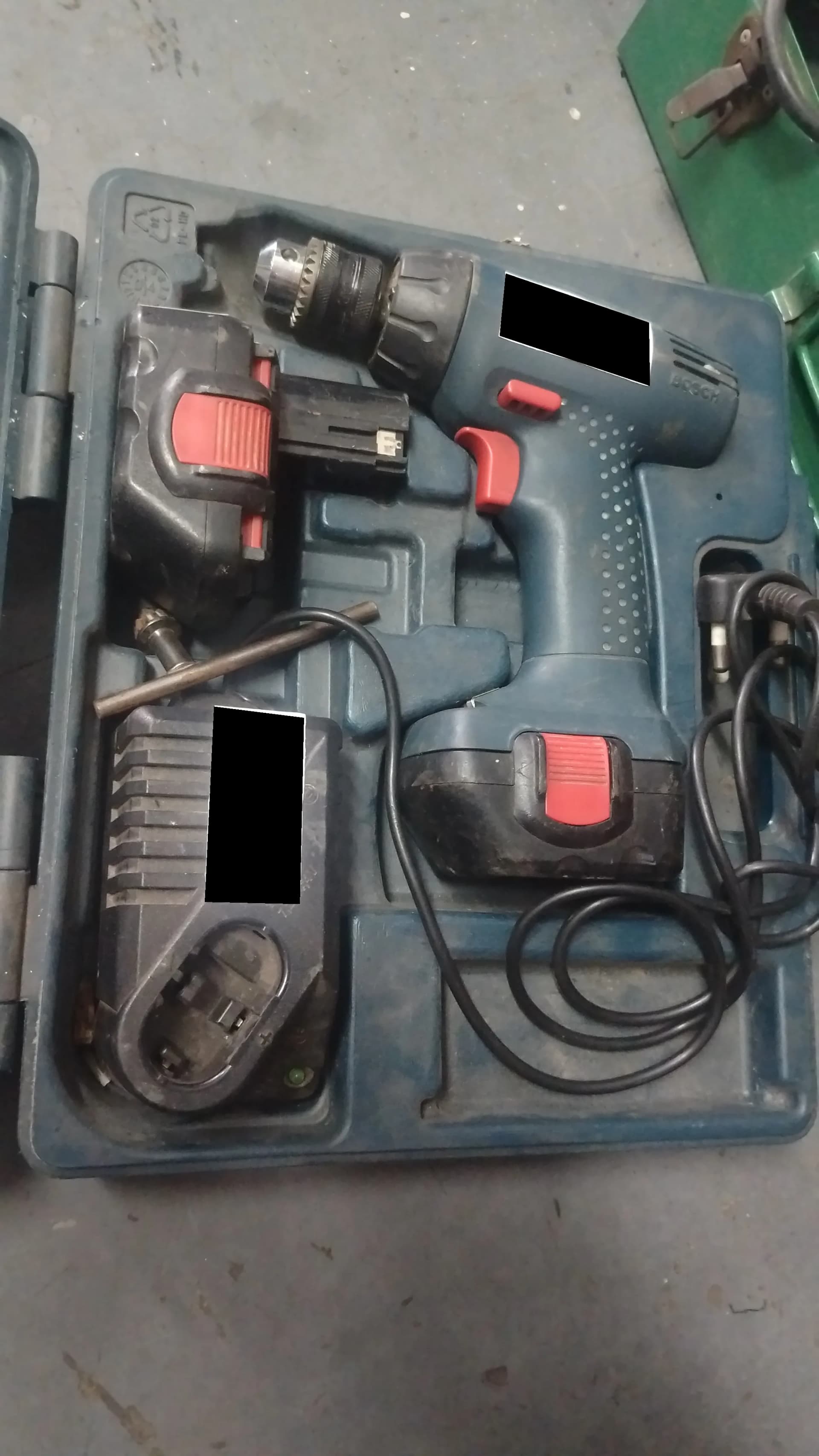 Used Bosch cordless drill with charger and extra battery in a case