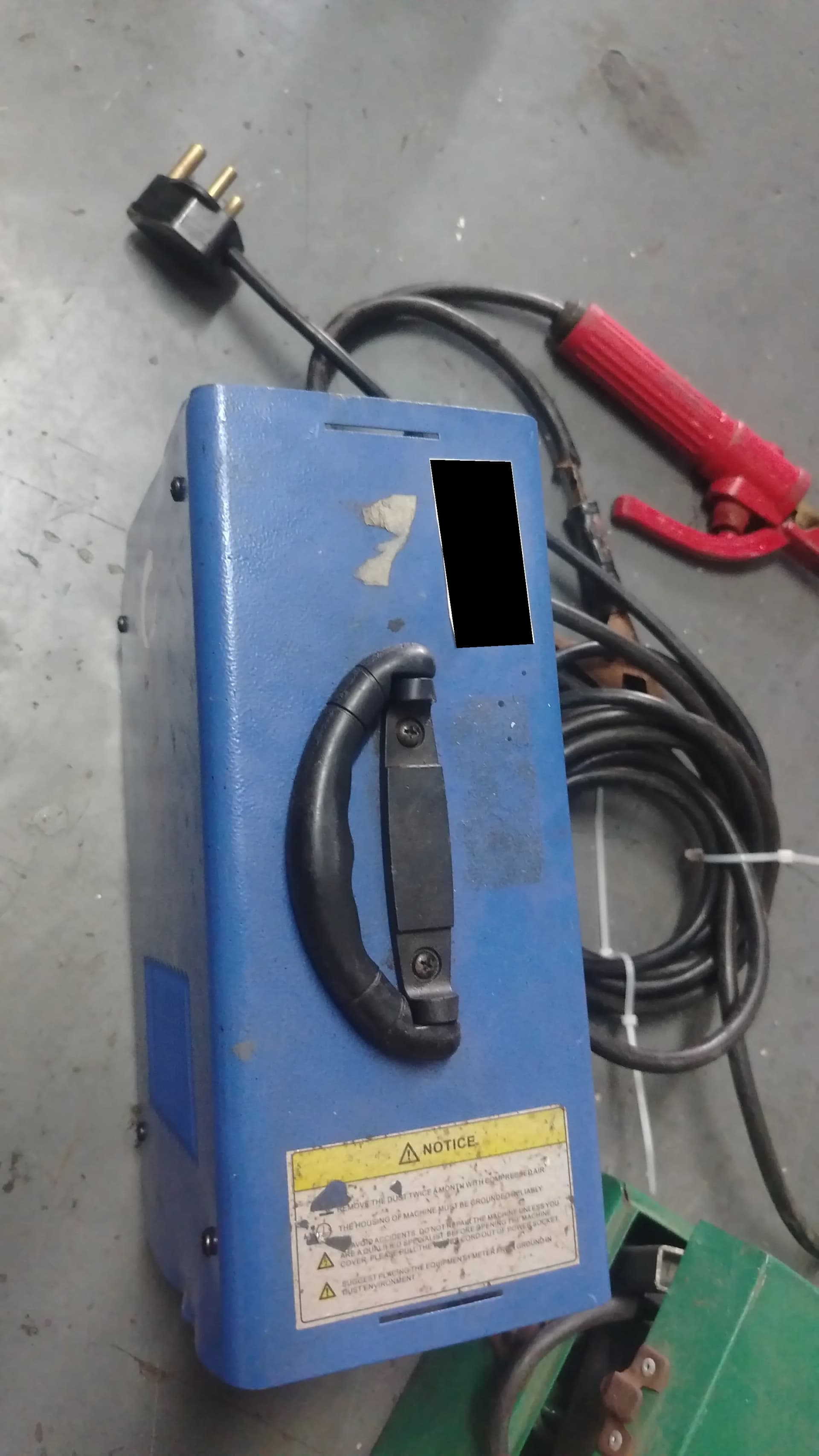 Used blue Mac Africa welding machine with a red electrode holder