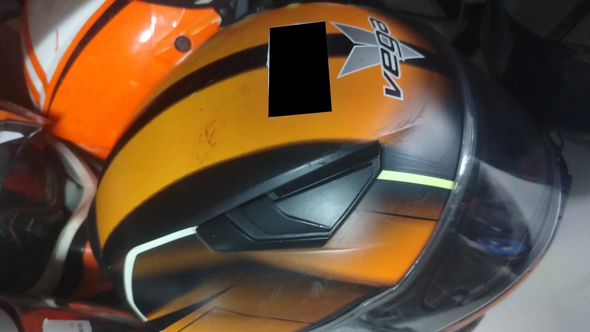 Used orange and black Vega size XL motorcycle helmet