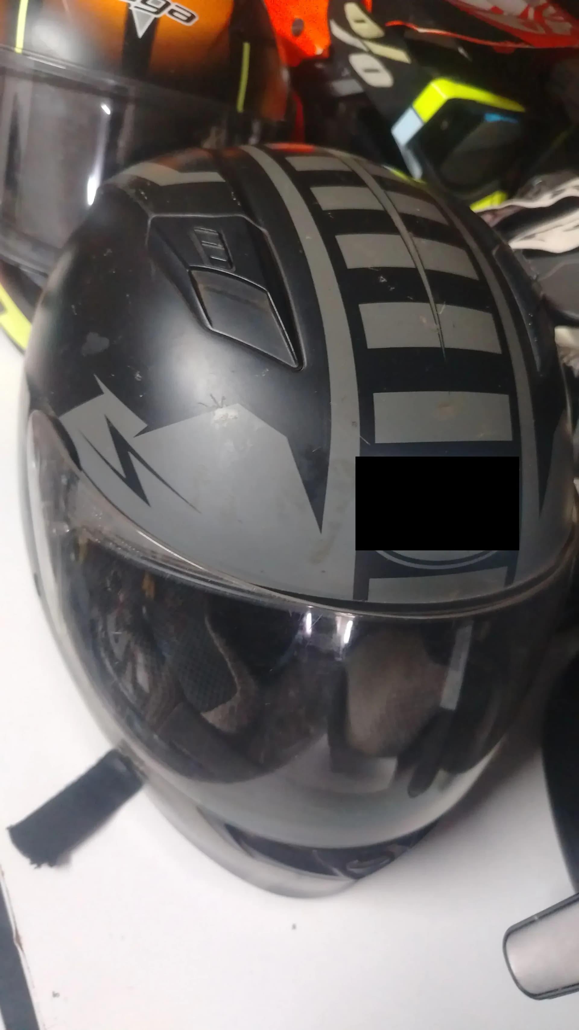 Used black motorcycle helmet with a grey graphic