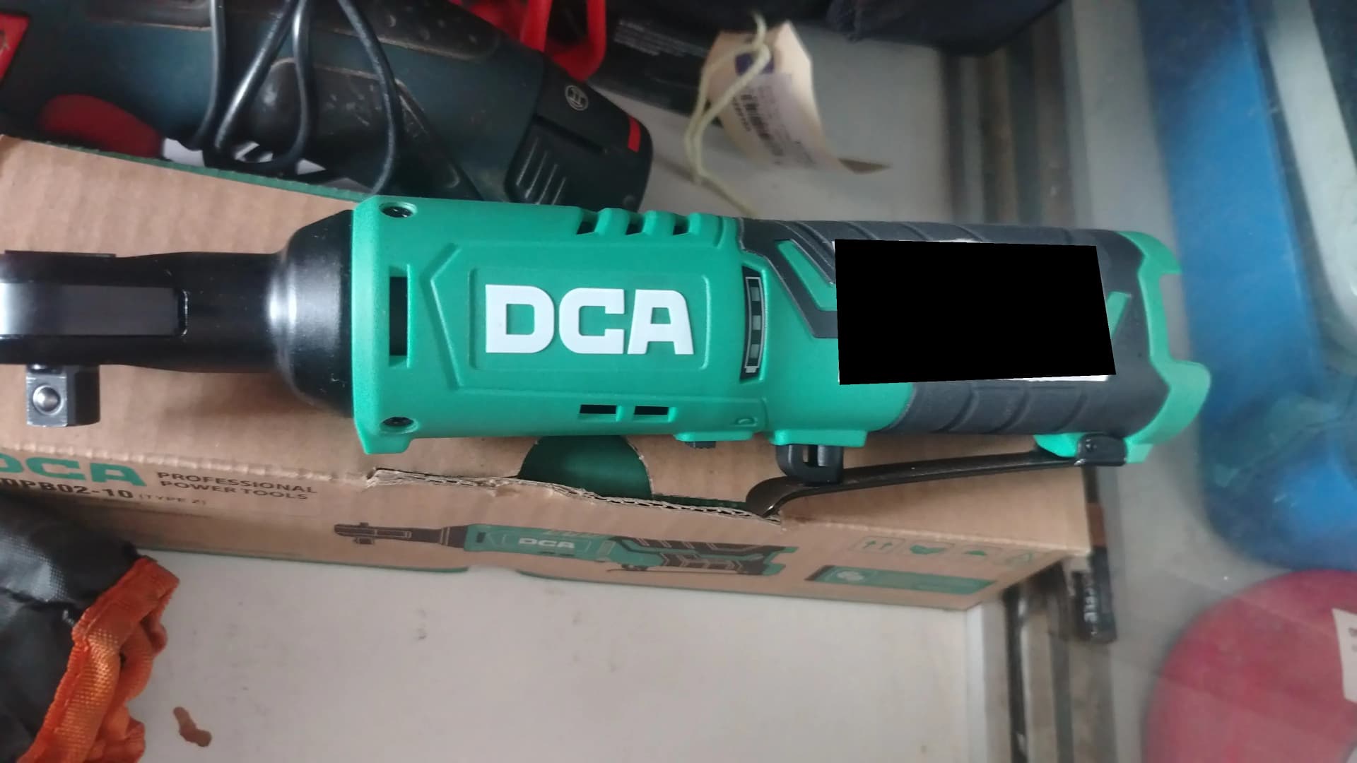 Used green DCA 12V cordless ratchet wrench on its box